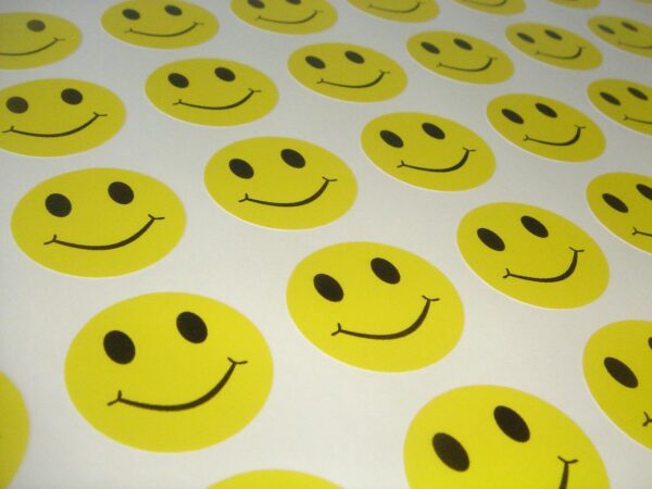 Fun bright yellow smiley face vinyl stickers on a sheet