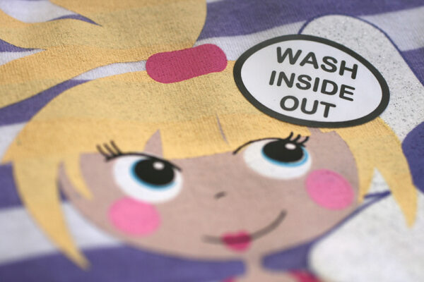 vinyl garment care sticker applied to clothing